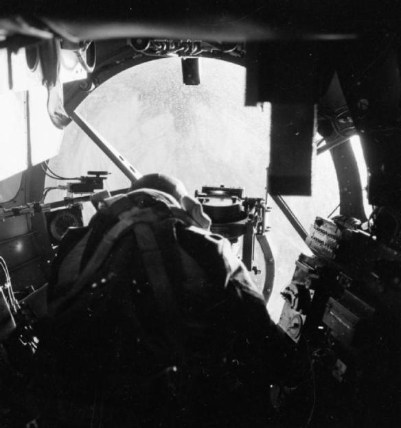 A Lancaster Bomb Aimer looks down to the target.
